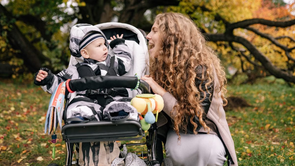 A joyful moment of a mother and child spending time together in a fall park.